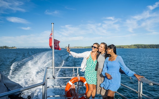 Women taking a selfie on a ferry to Waiheke Island, New Zealand.