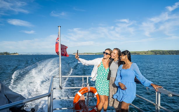 Women taking a selfie on a ferry to Waiheke Island, New Zealand.