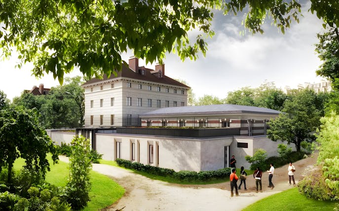 Liberation Museum in Paris surrounded by lush greenery and visitors exploring the grounds.