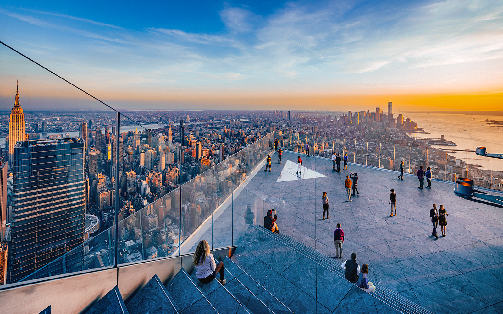 Visitors enjoying the view from Edge Observation Deck in New York City at sunset.