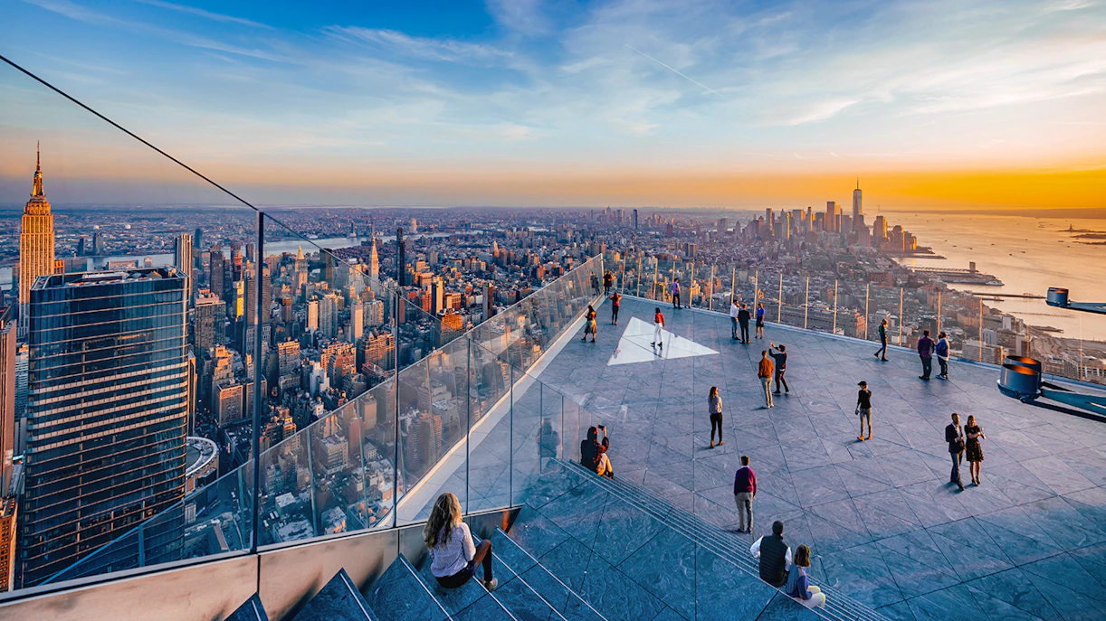 Visitors enjoying the view from Edge Observation Deck in New York City at sunset.