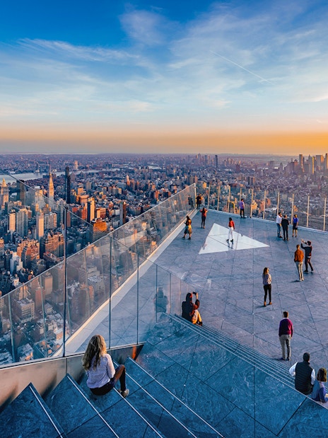 Visitors enjoying the view from Edge Observation Deck in New York City at sunset.