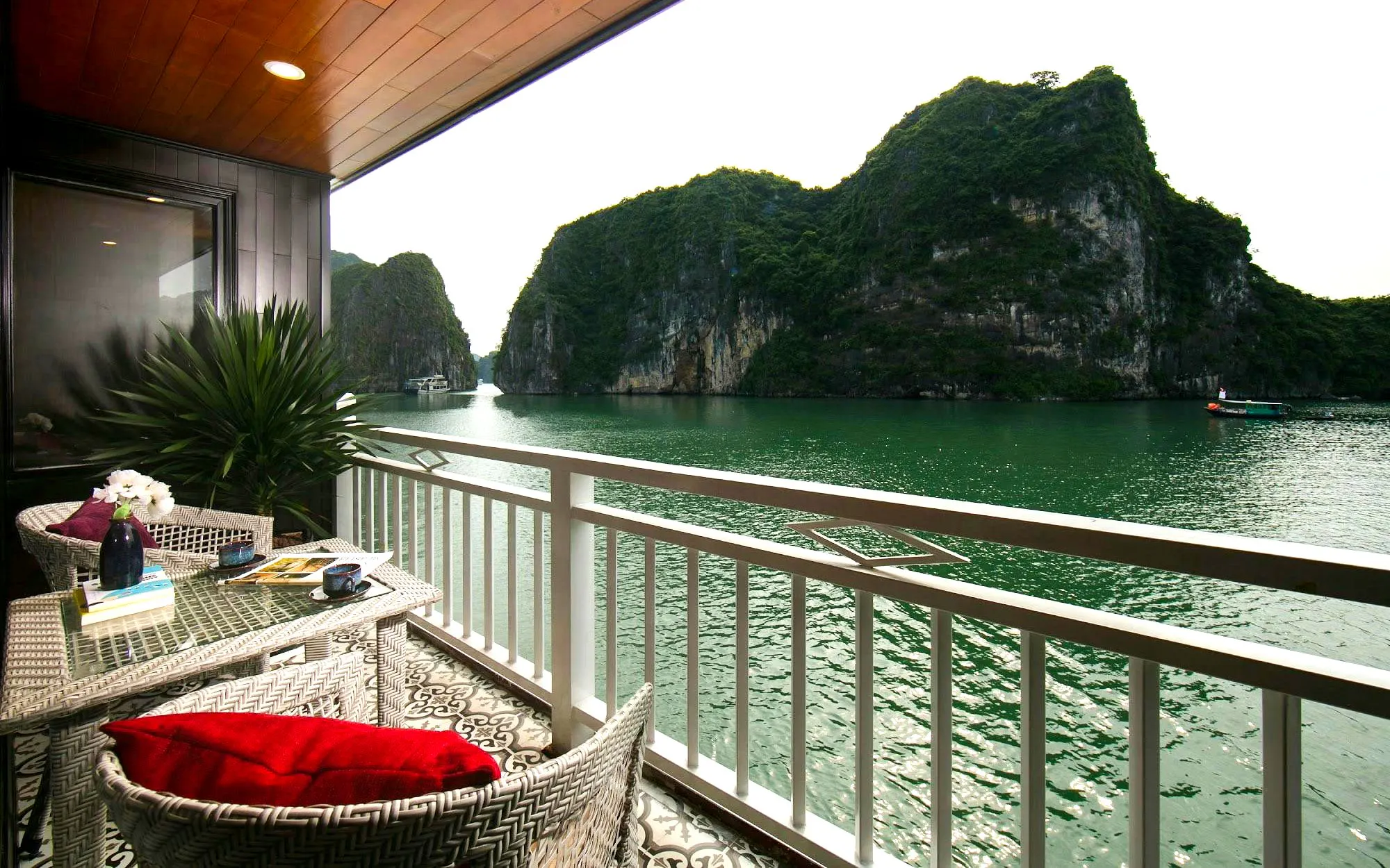 Junior double cabin balcony view of limestone karsts in Ha Long Bay on 5-star premium cruise.
