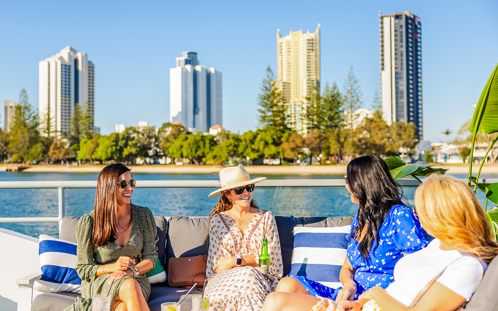 Ladies enjoying Gold Coast buffet lunch on top deck with city skyline.