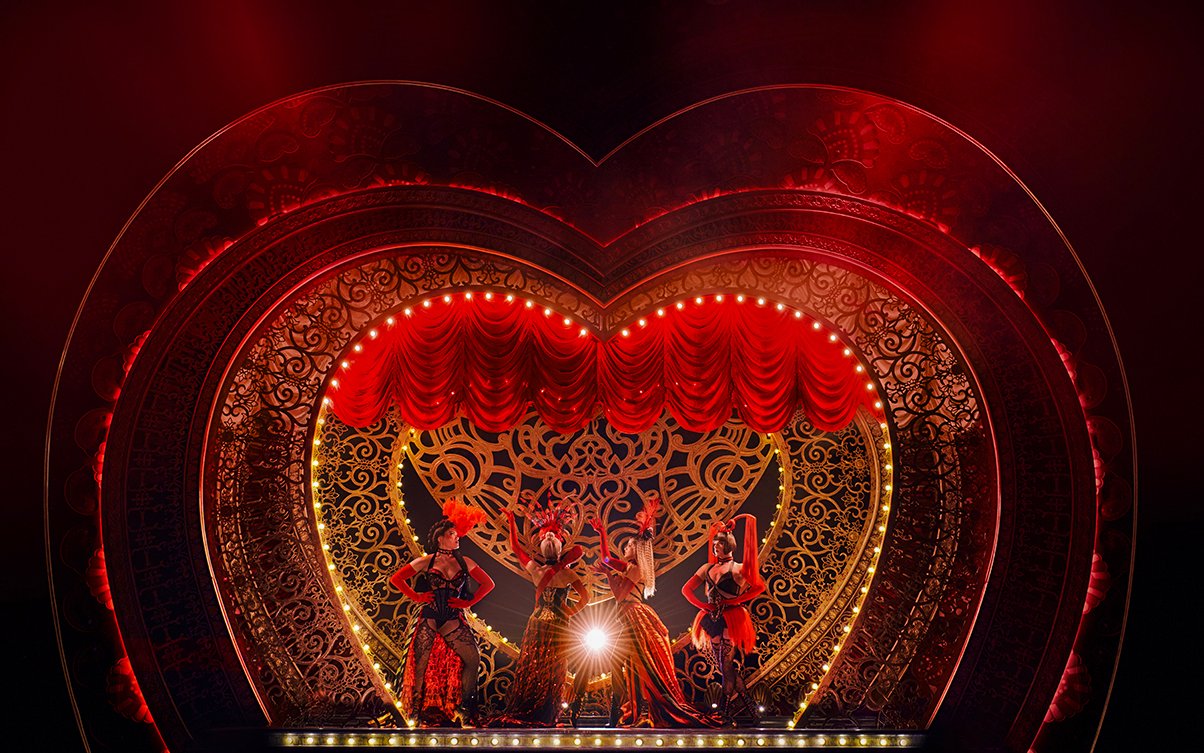 Stage performance of Come Alive Westend with dancers in ornate costumes on a heart-shaped set.