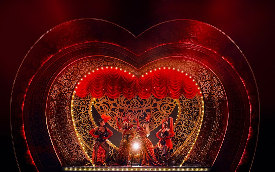 Stage performance of Come Alive Westend with dancers in ornate costumes on a heart-shaped set.