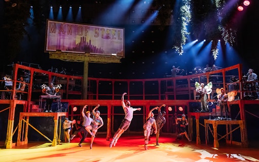 Dancers performing on stage with musicians in the background, Illinois.