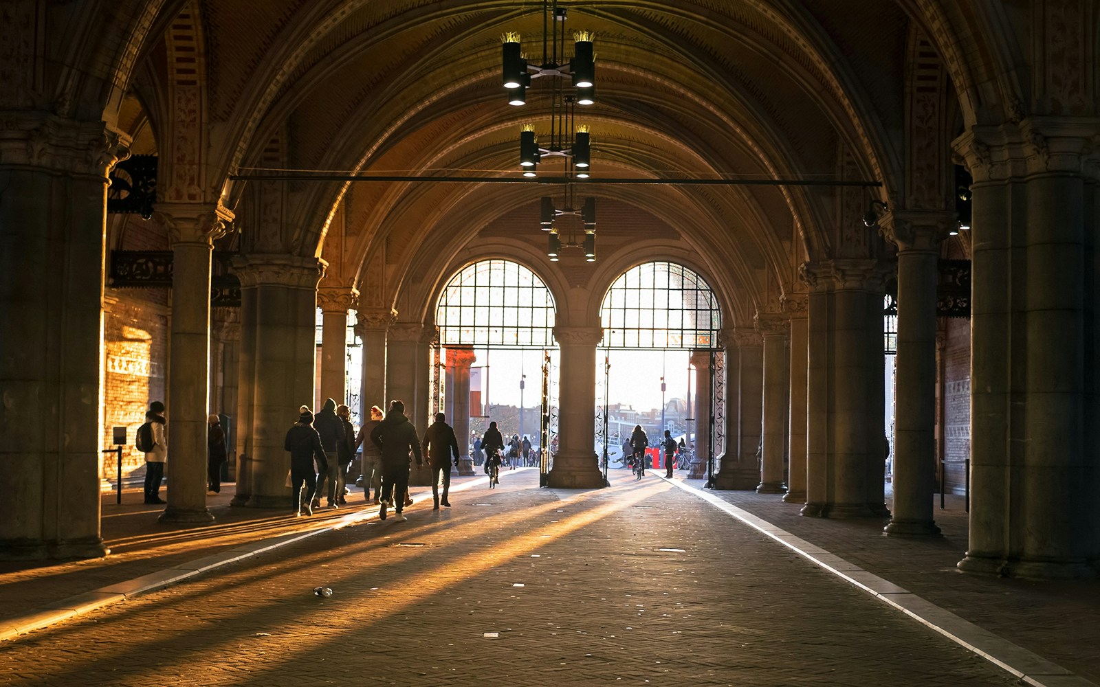 Visitors walking towards the Rijksmuseum entrance in Amsterdam.