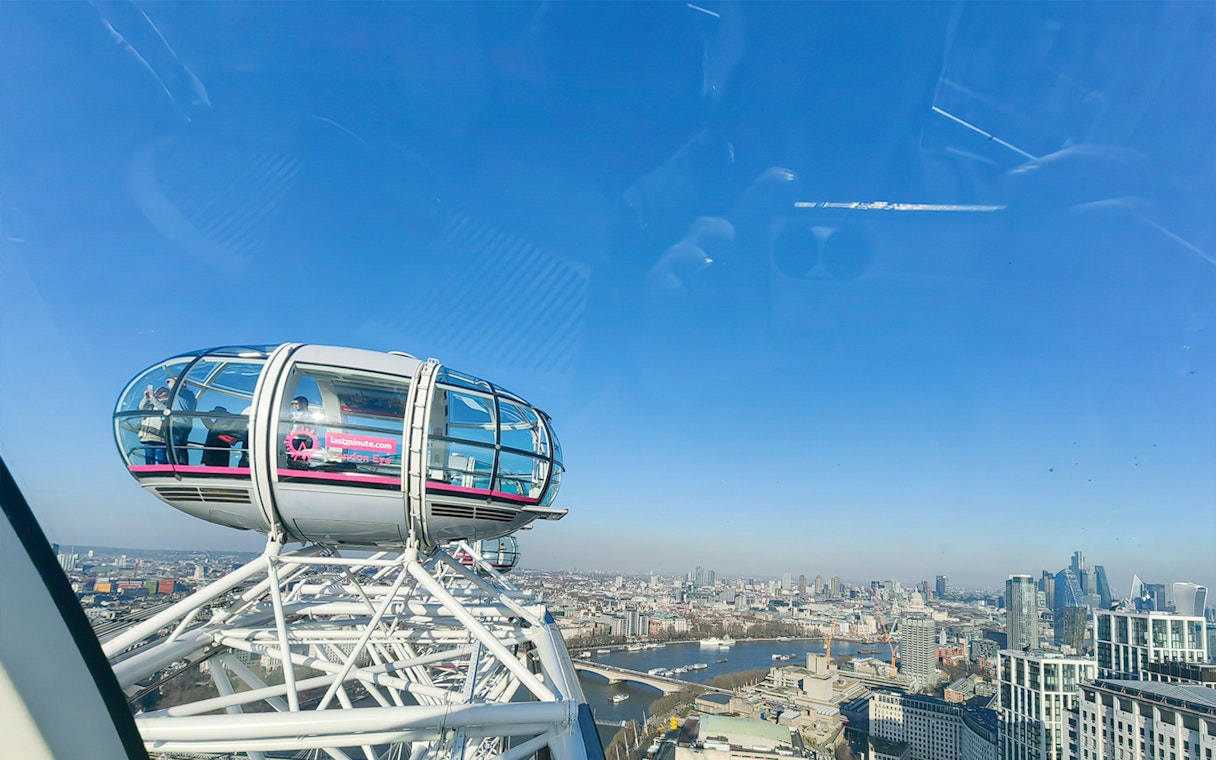 London Eye capsule with city skyline view, River Thames visible below.
