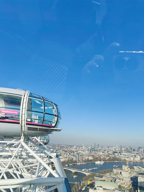 London Eye capsule with city skyline view, River Thames visible below.