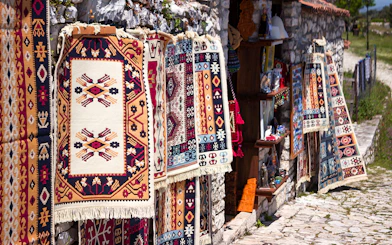 Traditional Albanian carpets displayed for sale near Berat fortress.