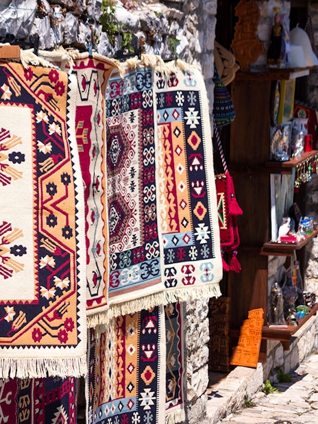 Traditional Albanian carpets displayed for sale near Berat fortress.