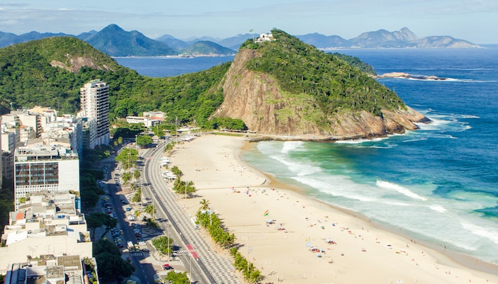 Copacabana Beach in Leme District, Rio de Janeiro, with Sugarloaf Mountain in the background.