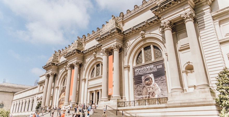 Metropolitan Museum of Art entrance with visitors entering the iconic New York City landmark.
