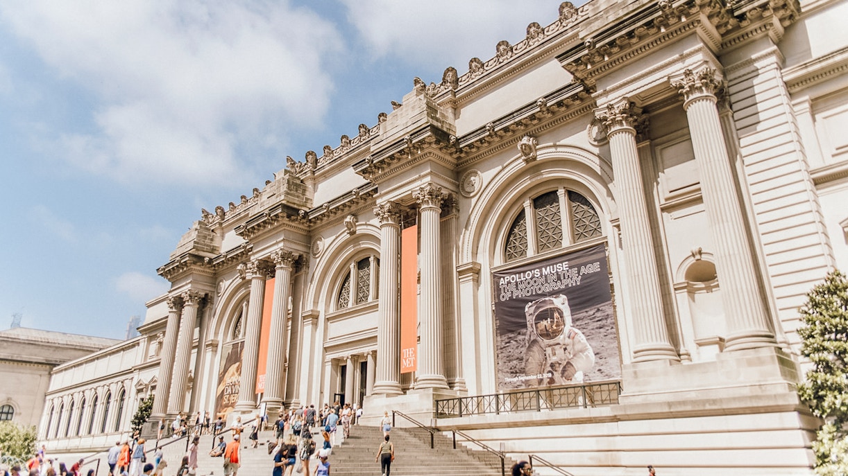 Metropolitan Museum of Art entrance with visitors entering the iconic New York City landmark.