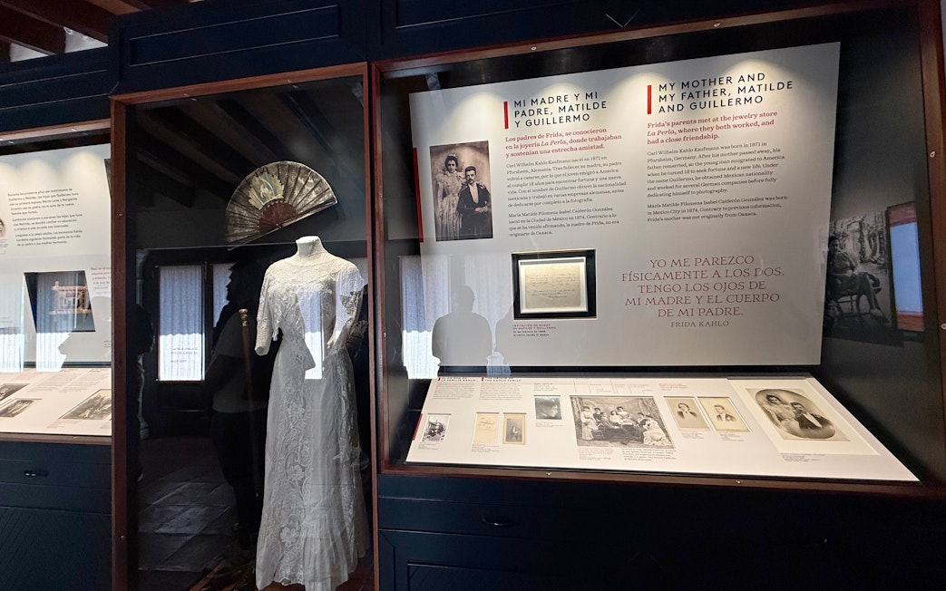 Exhibit at Frida Kahlo Museum featuring family history and a traditional dress.
