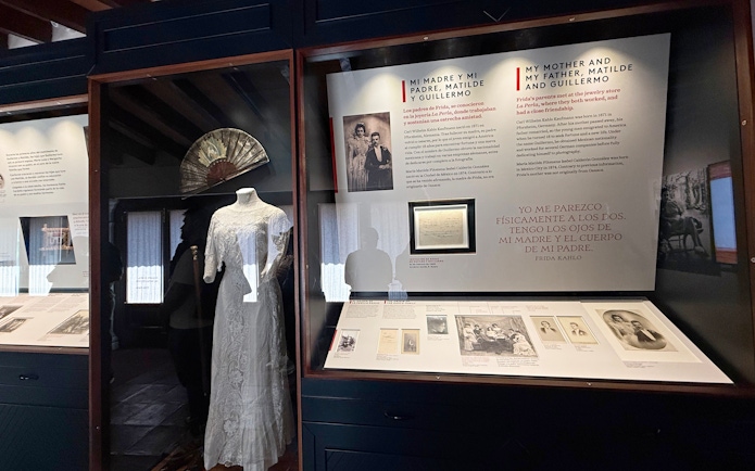 Exhibit at Frida Kahlo Museum featuring family history and a traditional dress.