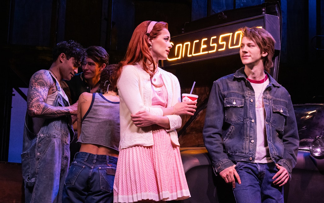 Group of young people in 1960s attire at a concession stand, related to "The Outsiders.