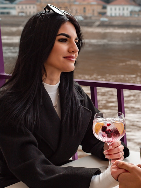 Couple enjoying cocktails on a Danube cruise in Budapest.
