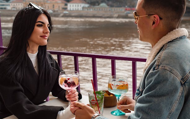Couple enjoying cocktails on a Danube cruise in Budapest.