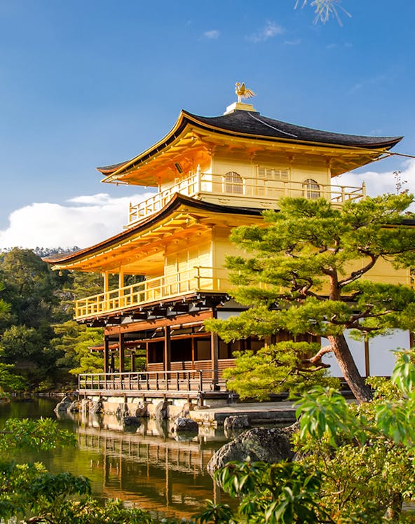 Golden Pavilion at Kinkaku-ji Temple, Kyoto, surrounded by trees and reflecting in a pond.