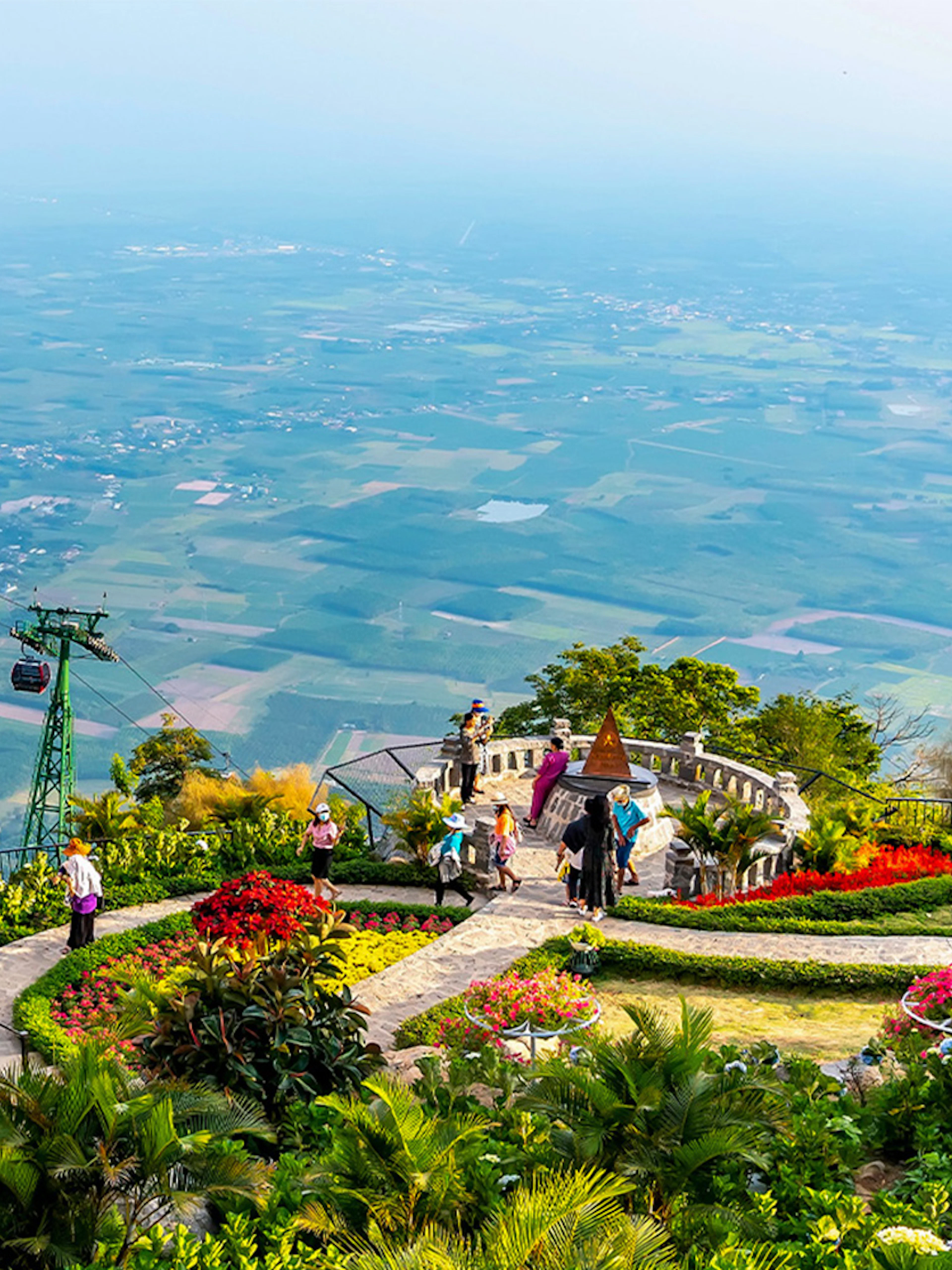 Cable cars over lush gardens at Sun World Ba Den Mountain, Vietnam.