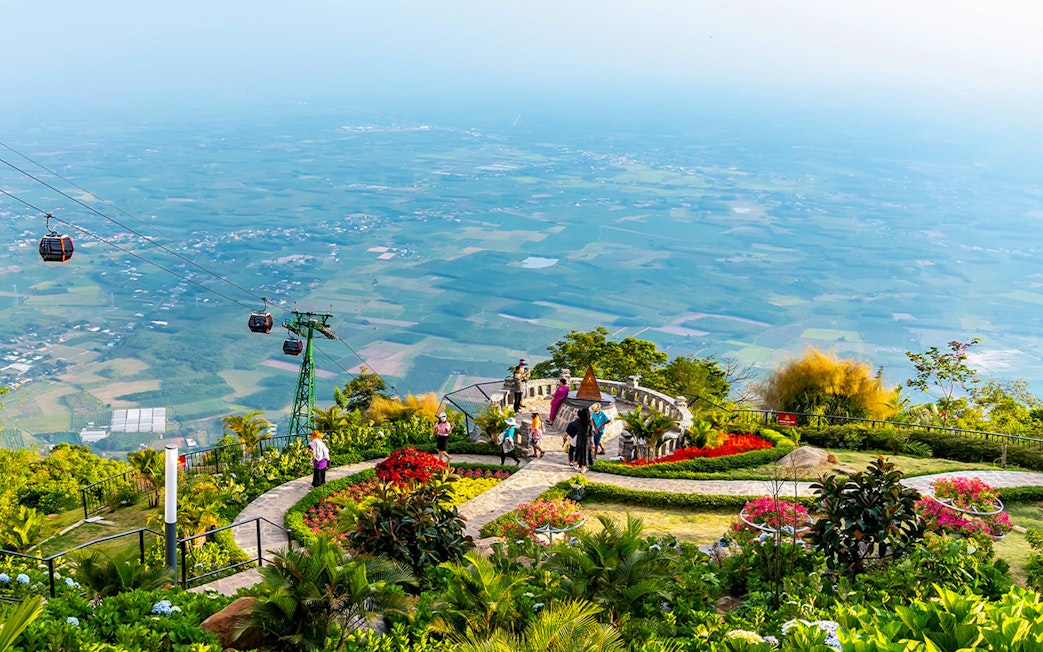 Cable cars over lush gardens at Sun World Ba Den Mountain, Vietnam.
