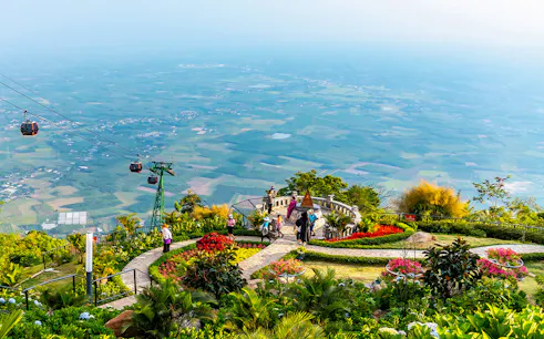 Cable cars over lush gardens at Sun World Ba Den Mountain, Vietnam.