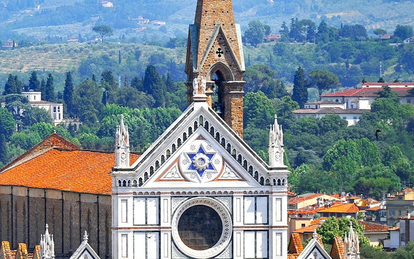 Basilica of Santa Croce facade with bell tower in Florence, Italy.