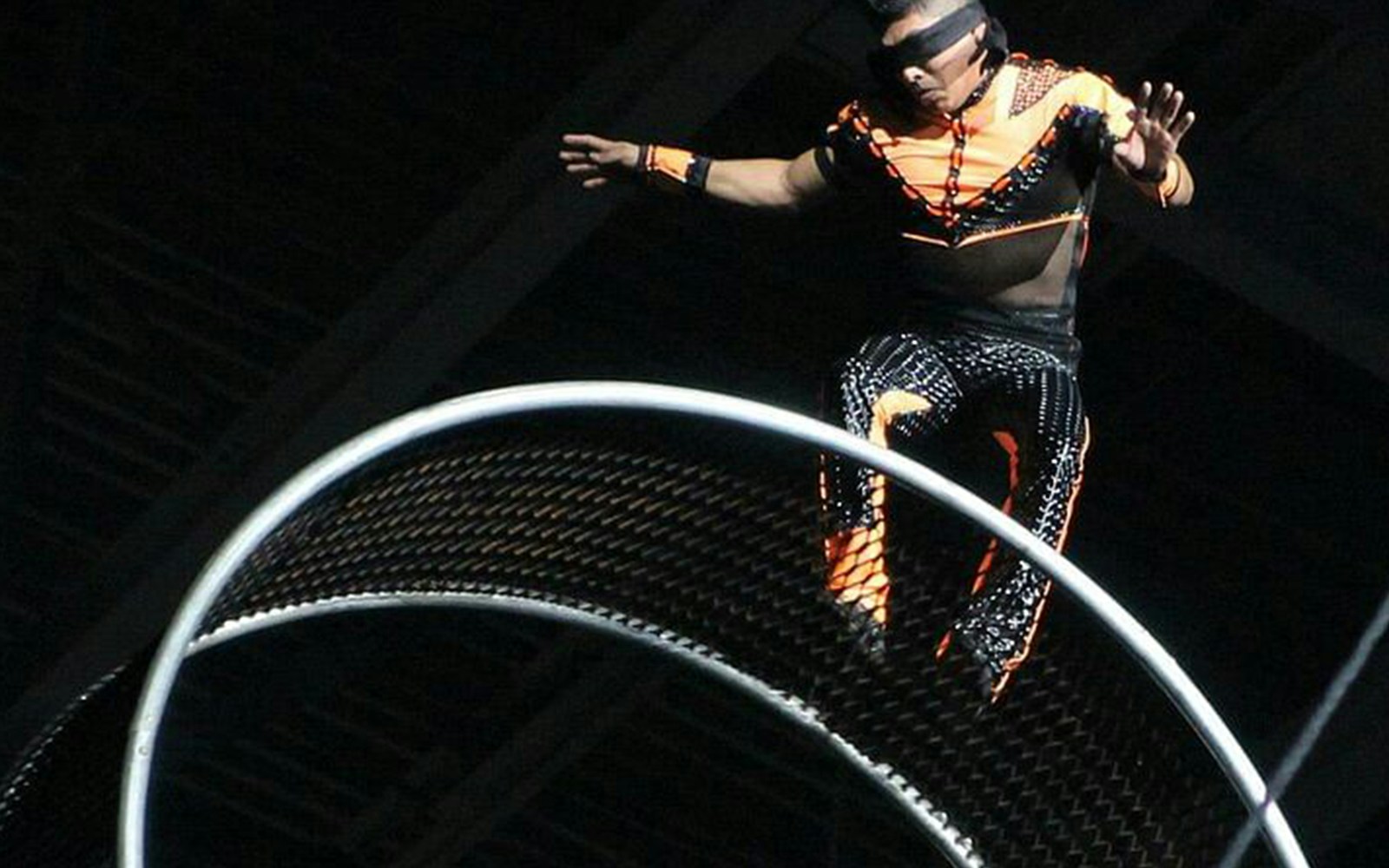 Performer balancing on a spinning wheel at Big Apple Circus Holiday Show.