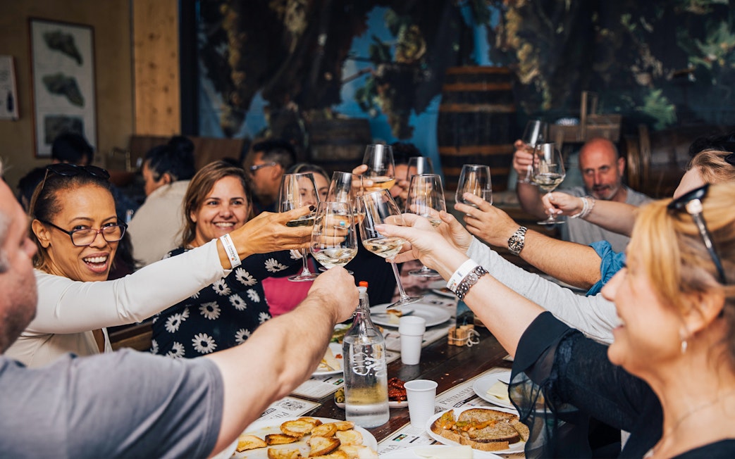 Group enjoying wine tasting in Tuscany during Siena, San Gimignano, and Pisa tour.