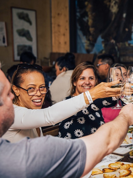 Group enjoying wine tasting in Tuscany during Siena, San Gimignano, and Pisa tour.