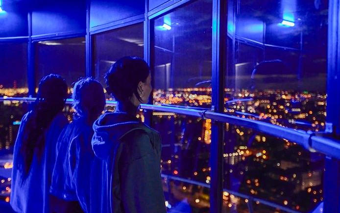 Guests enjoying the night view from Euromast viewing area in Rotterdam.