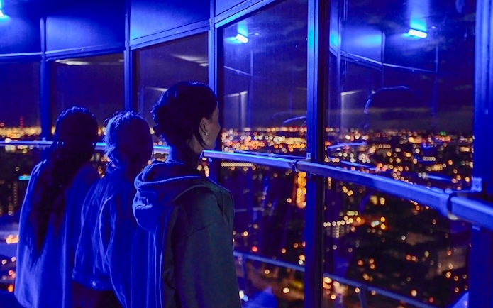 Guests enjoying the night view from Euromast viewing area in Rotterdam.