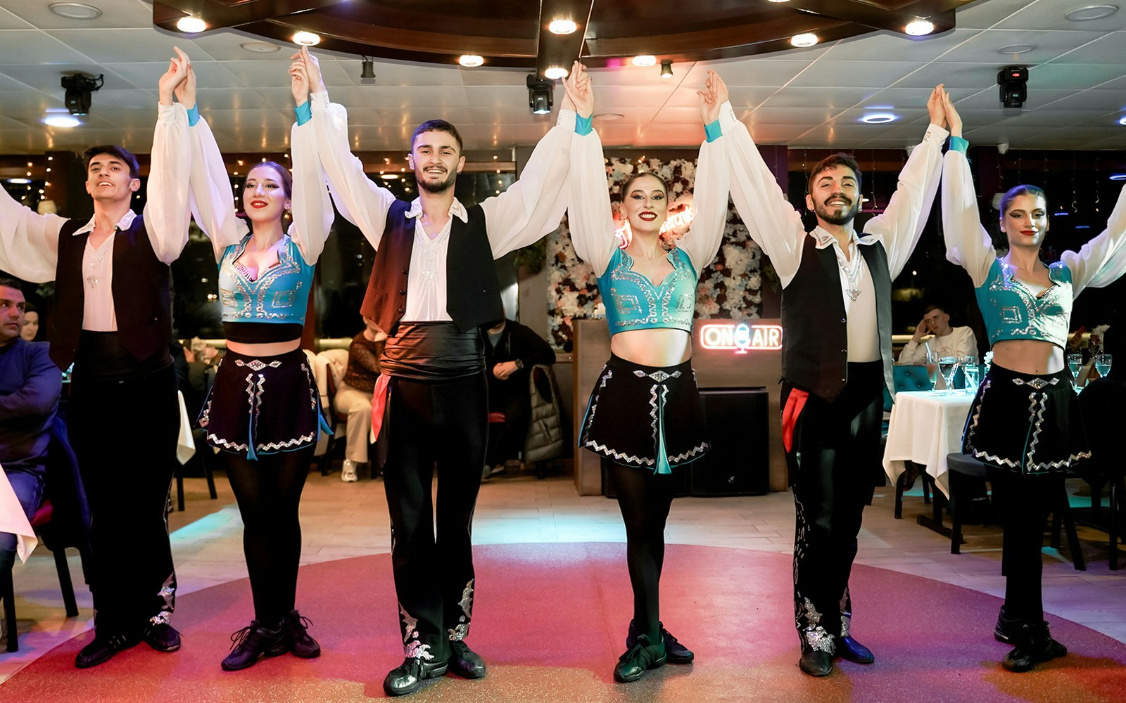 Bosphorus dinner cruise with Turkish show, featuring traditional dancers and illuminated Istanbul skyline.