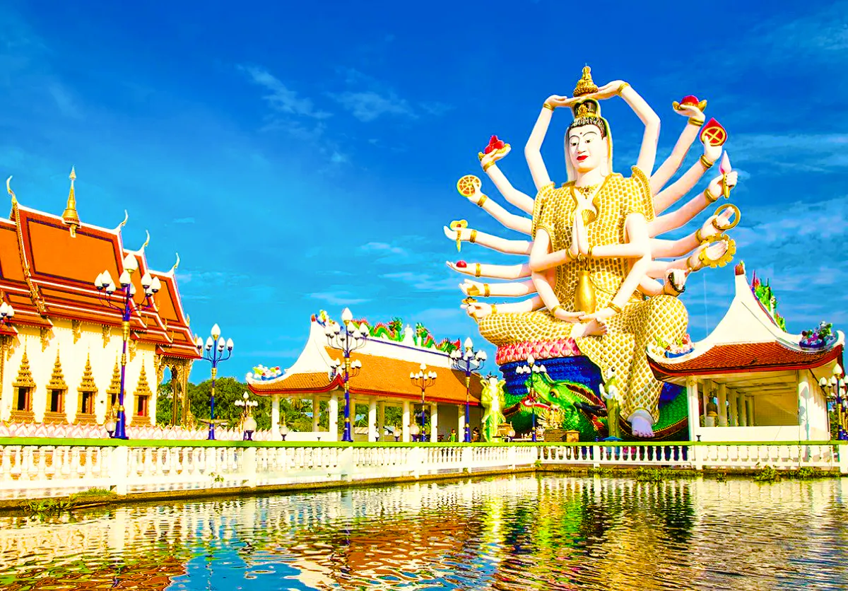 Wat Plai Laem temple with Guanyin statue, Koh Samui, reflecting in a pond.
