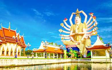 Wat Plai Laem temple with Guanyin statue, Koh Samui, reflecting in a pond.