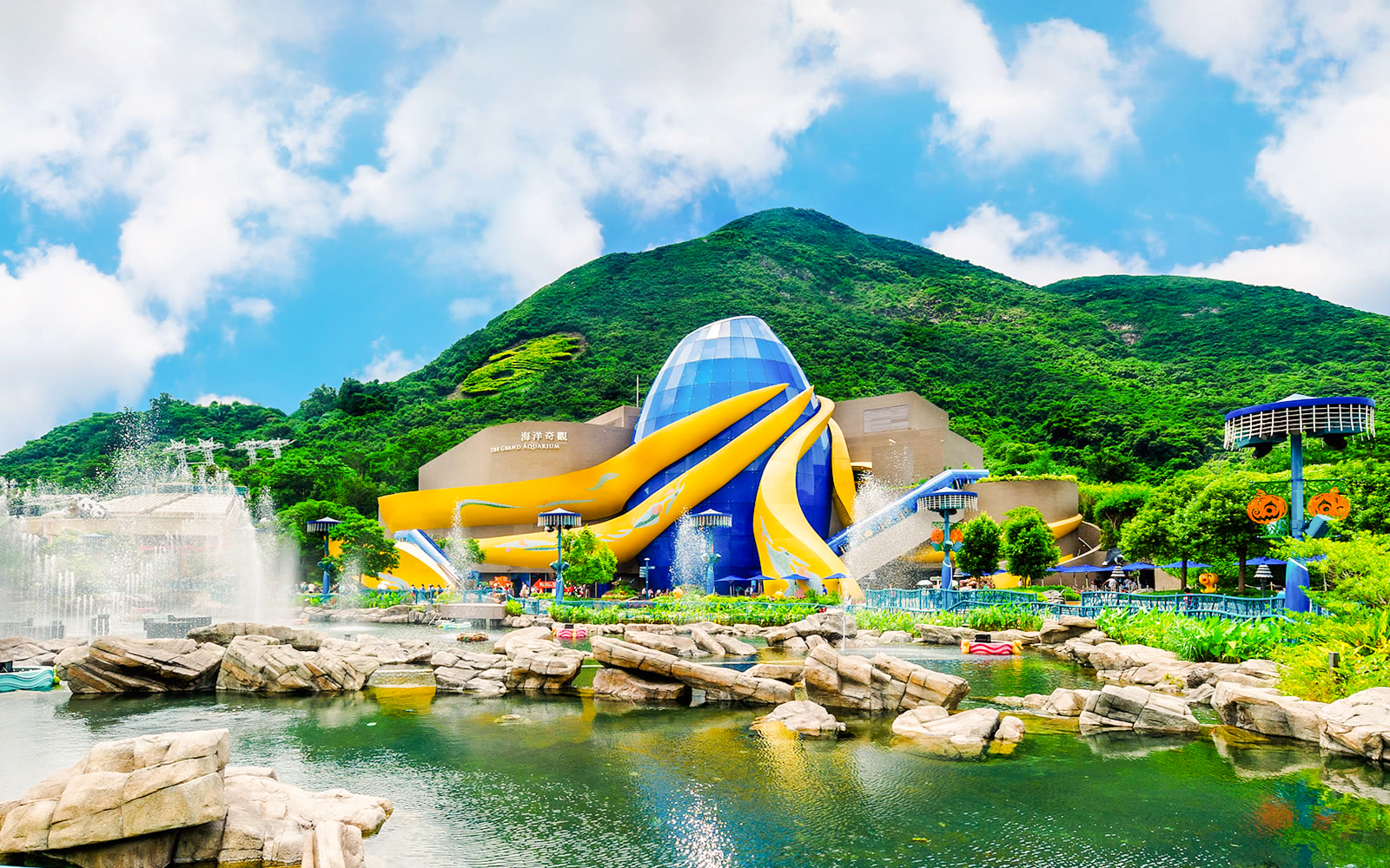 The Grand Aquarium at Ocean Park, Hong Kong with vibrant architecture and surrounding greenery.