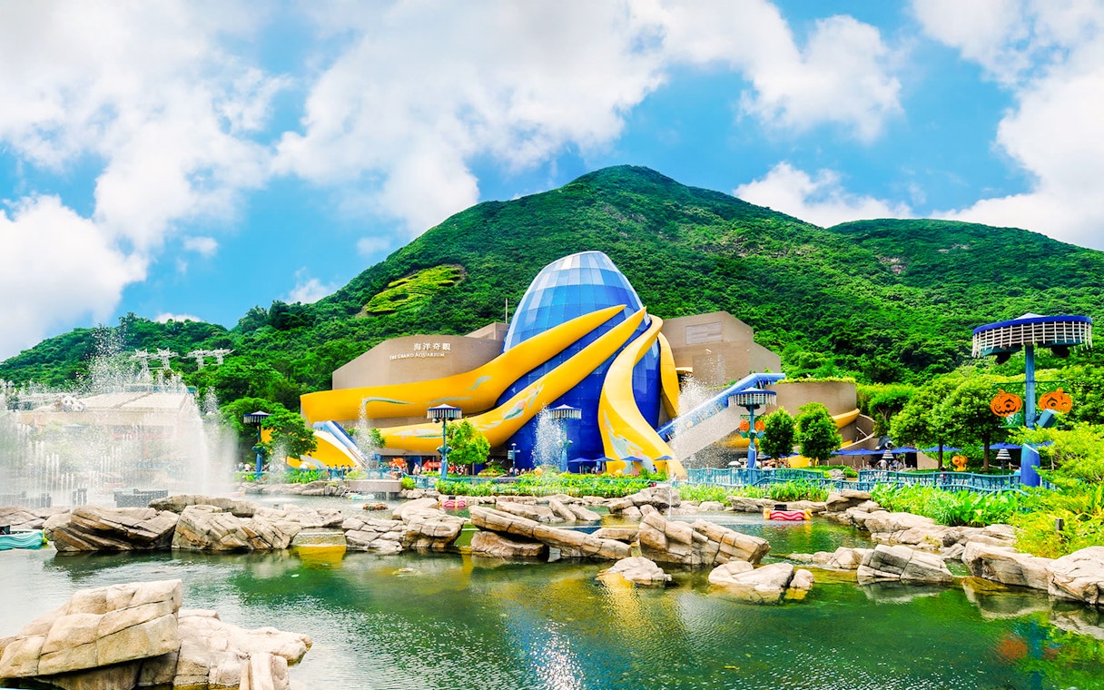 The Grand Aquarium at Ocean Park, Hong Kong with vibrant architecture and surrounding greenery.