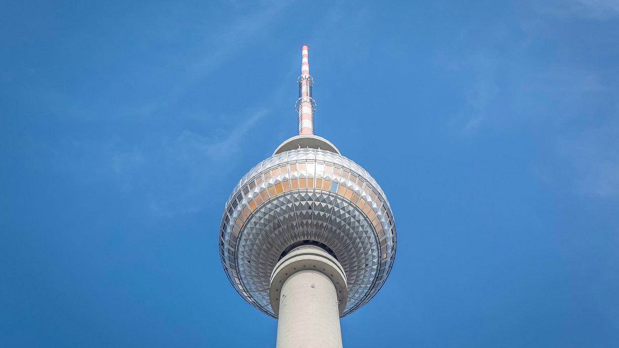Berlin TV Tower against clear blue sky.