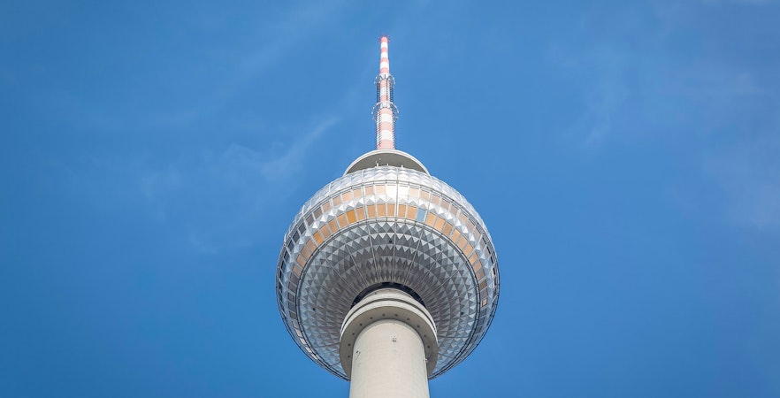 Berlin TV Tower against clear blue sky.