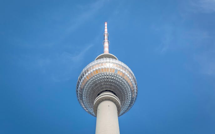 Berlin TV Tower against clear blue sky.