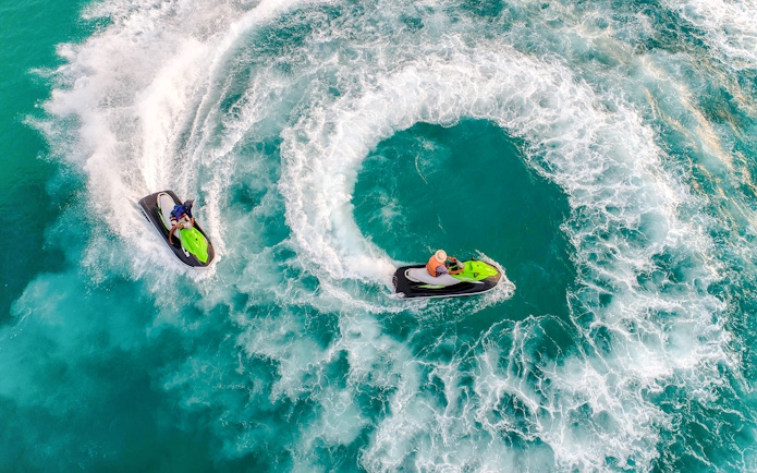 Group jet skiing on turquoise waters during Langkawi Island Hopping tour.