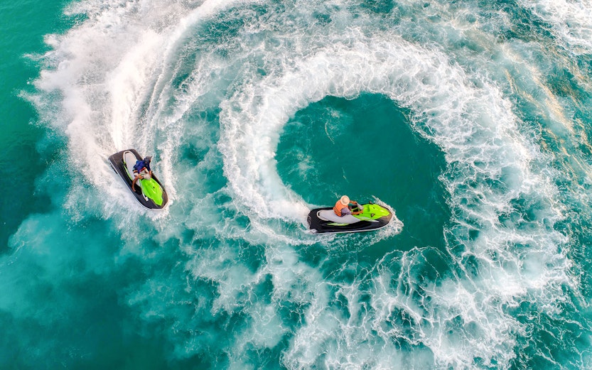 Group jet skiing on turquoise waters during Langkawi Island Hopping tour.