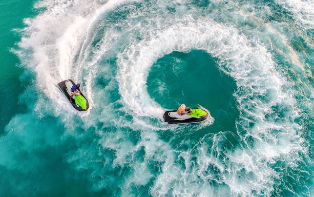 Group jet skiing on turquoise waters during Langkawi Island Hopping tour.