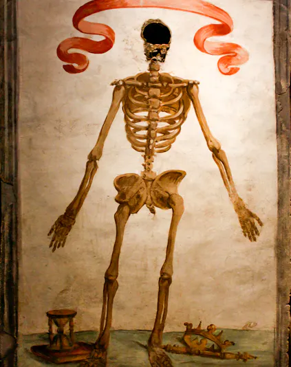 Skeleton mural with hourglass and crown in Catacombs of San Gaudioso, Naples.