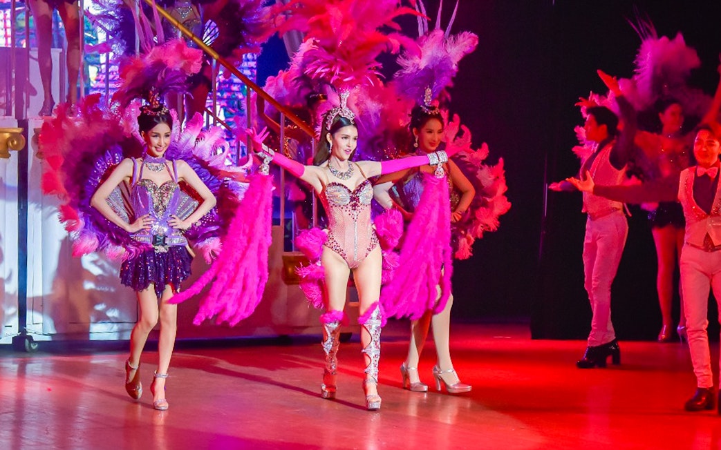 Performers in vibrant costumes on stage at the Golden Dome Cabaret Show.