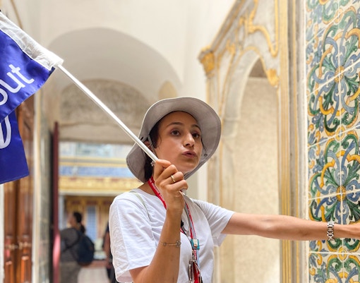 Guide explaining interiors of Topkapi Palace, Istanbul, with intricate designs and historical artifacts.