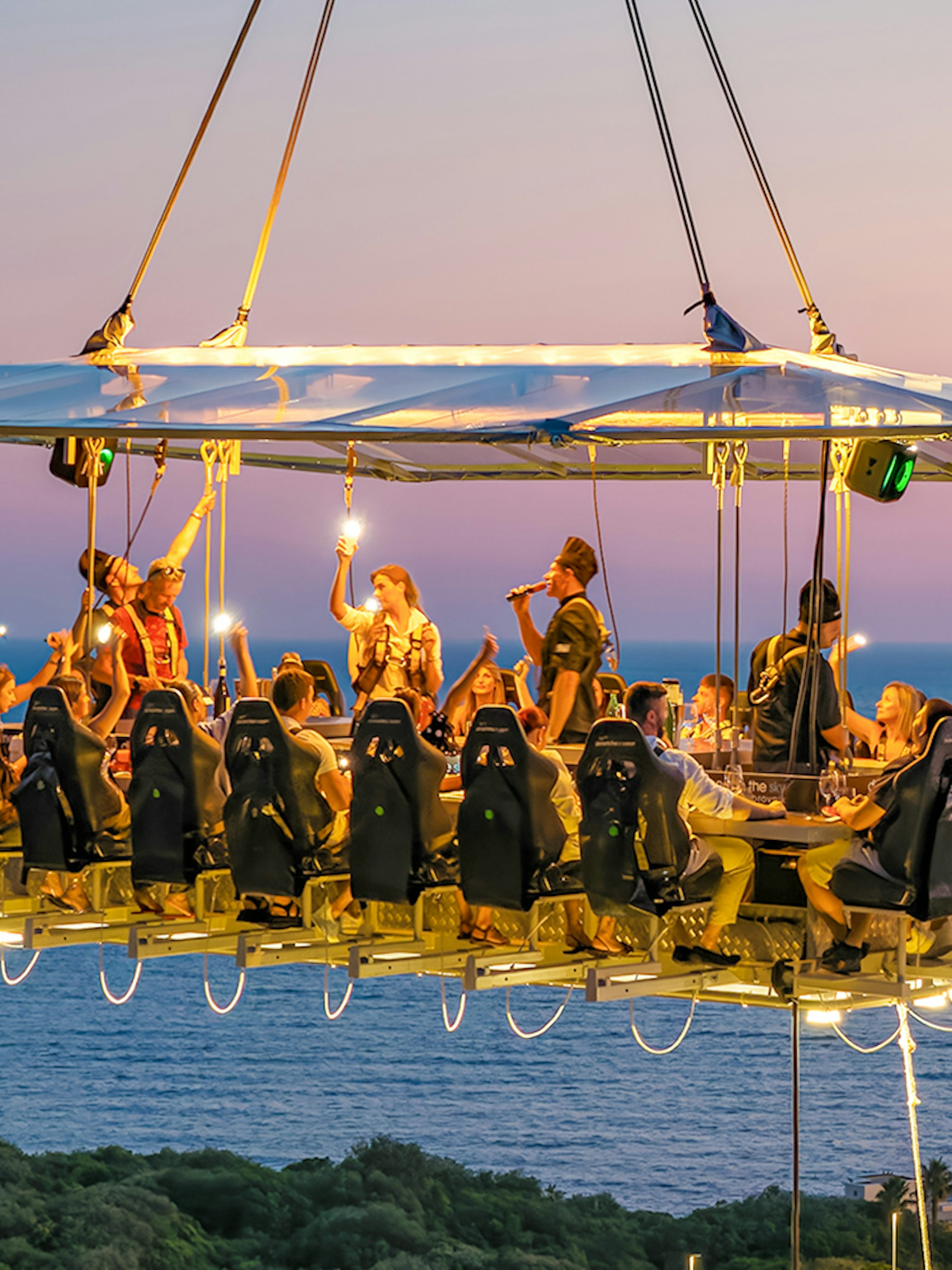 Guests dining at suspended table with ocean view in Dubrovnik.