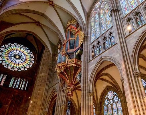 Notre Dame's Great Organ with intricate pipes and historic architecture in Paris, France.